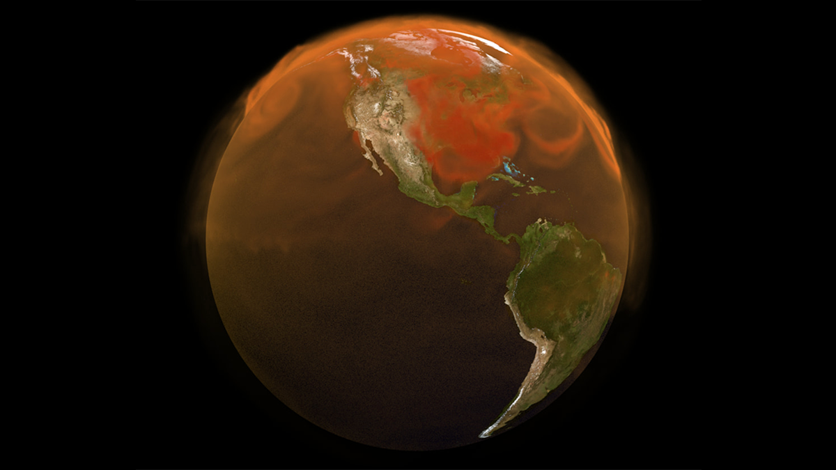 This circular view of Earth captures most of North and South America, as well as a large portion of the Pacific Ocean. The landmasses appear in green and brown, and the water in dark gray. Both land and ocean are obscured by overlying misty, orange swirls representing carbon dioxide in the atmosphere, which are thicker over certain regions, such as the U.S. East Coast.