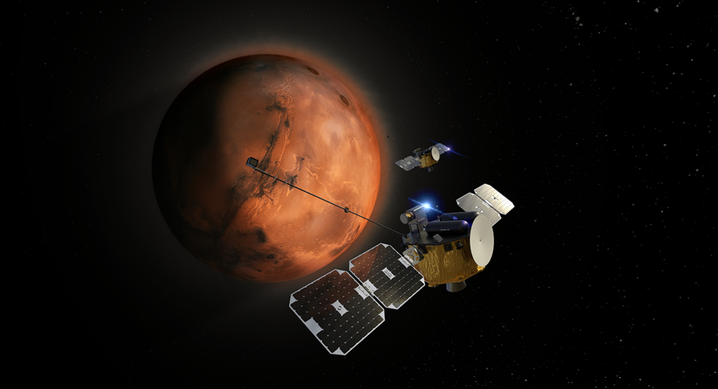 The two ESCAPADE spacecraft align near Mars, which is a shaded orange, brown, and black sphere against black space.